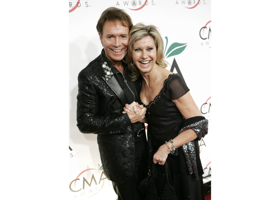 FILE - Singer Olivia-Newton John arrives with British recording artist Cliff Richard for the 39th Annual Country Music Association Awards in New York on Nov. 15, 2005. Newton-John, a longtime resident of Australia whose sales topped 100 million albums, died Monday at her southern California ranch, John Easterling, her husband, wrote on Instagram and Facebook. She was 73. (AP Photo/Stuart Ramson, File)