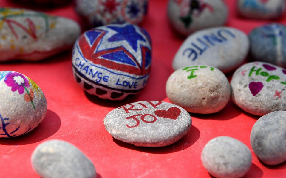 Children decorate pebbles as people attend a Great Get Together  - Credit: Getty