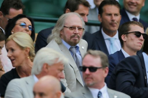 Friday afternoon fever: British singer Barry Gibb takes his seat in the Royal box on Centre Court