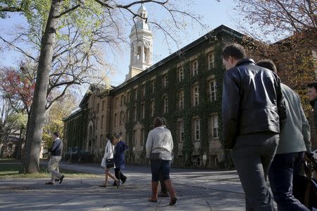 People walk past Princeton University's Nassau Hall in Princeton, New Jersey, November 20, 2015. REUTERS/Dominick Reuter
