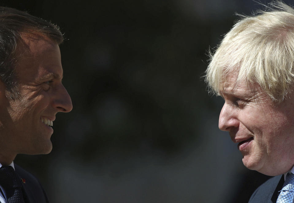 FILE - French President Emmanuel Macron welcomes Britain's Prime Minister Boris Johnson at the Elysee Palace, Thursday, Aug. 22, 2019 in Paris. The moving vans have already started arriving in Downing Street, as Britain's Conservative Party prepares to evict Johnson. Debate about what mark he will leave on his party, his country and the world will linger long after he departs in September. (AP Photo/Daniel Cole, File)