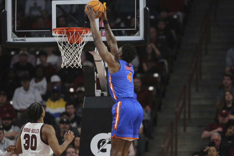 Florida forward Tyrese Samuel (4) dunks the ball over South Carolina forward Collin Murray-Boyles (30) during the first half of an NCAA college basketball game Saturday, March 2, 2024, in Columbia, S.C. (AP Photo/Artie Walker Jr.)