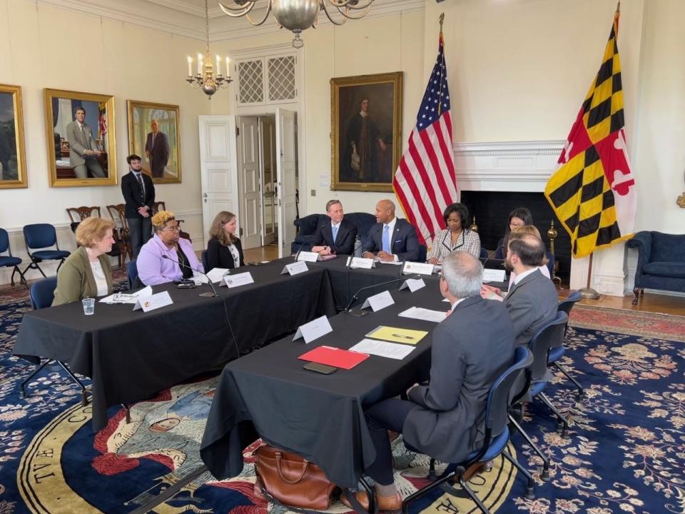 Gov. Wes Moore, in front of American flag, speaks during a roundtable discussion on the state's climate goals in Annapolis on Monday, April 3, 2023. At the table were representatives from the Maryland Department of the Environment, University of Maryland, League of Conservation Voters, Maryland Commission on Environmental Justice and Sustainable Communities, and Blink Charging.