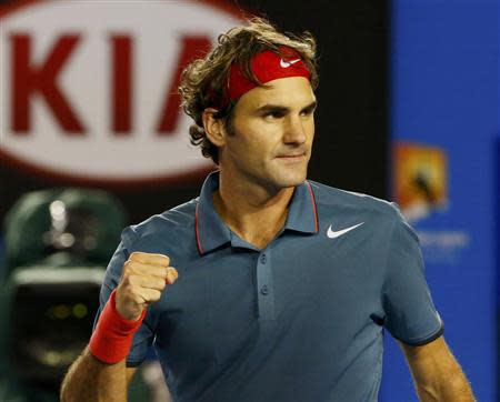 Roger Federer of Switzerland celebrates defeating Jo-Wilfried Tsonga of France during their men's singles match at the Australian Open 2014 tennis tournament in Melbourne January 20, 2014. REUTERS/Petar Kujundzic