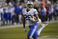 BYU's Tyler Allgeier (25) carries the ball before scoring against Utah State in the first half during an NCAA college football game Friday, Oct. 1, 2021, in Logan, Utah. (AP Photo/Rick Bowmer)