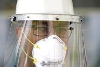 Dr. Robin Armstrong poses in his personal protection equipment outside the entrance to The Resort at Texas City nursing home, where he is the medical director, Tuesday, April 7, 2020, in Texas City, Texas. Armstrong is treating nearly 30 residents of the nursing home with the anti-malaria drug hydroxychloroquine, which is unproven against COVID-19 even as President Donald Trump heavily promotes it as a possible treatment. Armstrong said Trump's championing of the drug is giving doctors more access to try it on coronavirus patients. More than 80 residents and workers have tested positive for coronavirus at the nursing home. (AP Photo/David J. Phillip)