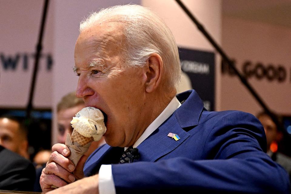 Biden eating an ice cream cone at an ice cream parlor.