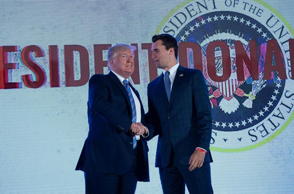 President Donald Trump shakes hands with Charlie Kirk, head of Turning Point USA, before addressing the group's Teen Student Action Summit in Washington, D.C., on July 23, 2019. (Photo: NICHOLAS KAMM via Getty Images)