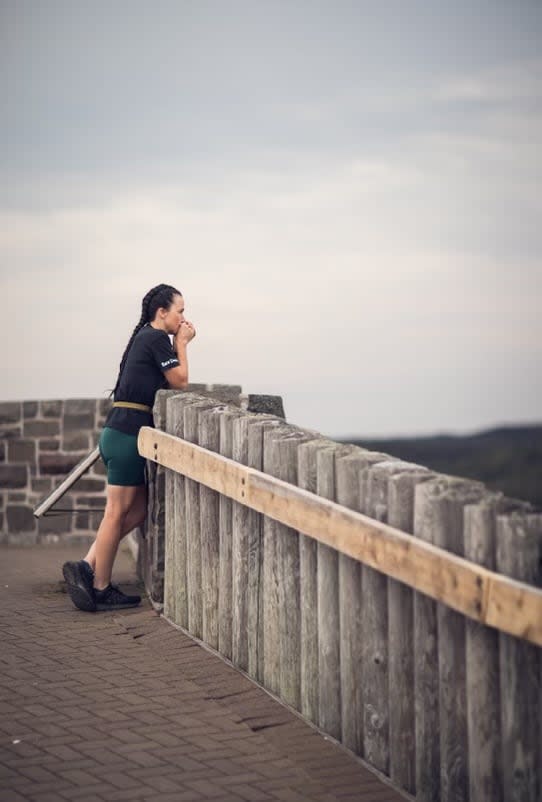 Tanya Joy watches runners wind down Signal Hill at the start of The Joy Run 50. She's taking a few moments to gather her emotions and to remember her brother Jody.