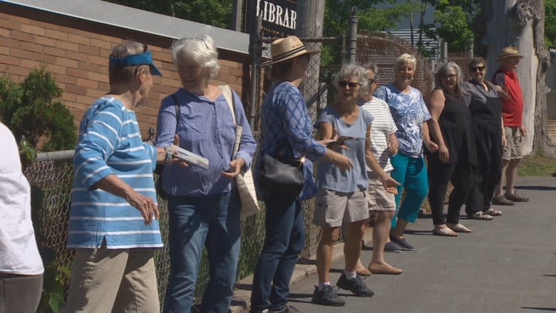 Hundreds gather to move books, one by one, into new Lunenburg library