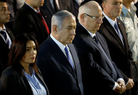 Israeli Prime Minister Benjamin Netanyahu and Israeli President Reuven Rivlin attend the funeral of Zachary Baumel, a U.S.-born Israeli soldier missing since a 1982 tank battle against Syrian forces and whose remains were recently recovered by Israel, at the Mount Herzl military cemetery in Jerusalem April 4, 2019. REUTERS/Ronen Zvulun