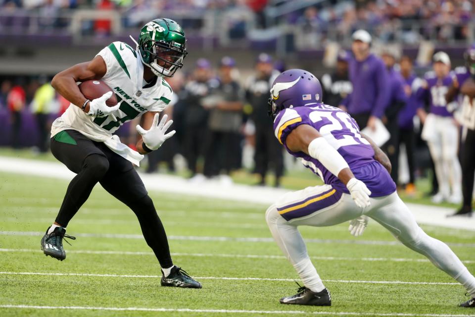 New York Jets wide receiver Garrett Wilson (17) runs from Minnesota Vikings cornerback Duke Shelley, right, after catching a pass during the second half of an NFL football game, Sunday, Dec. 4, 2022, in Minneapolis. (AP Photo/Bruce Kluckhohn)