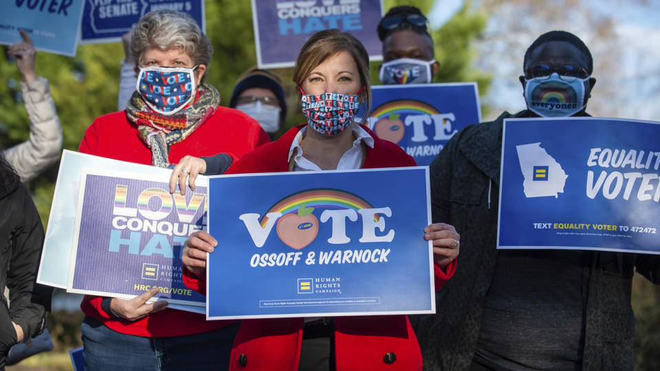 Human Rights Campaign Atlanta Governor Jen Slipakoff (center) poses for a photo with HRC supporters on Saturday Dec.19, 2020 during a get-out-the-vote event at a private residence in Dunwoody, Ga. (Bita Honarvar/AP Images for The Human Rights Campaign)