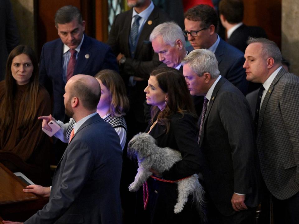 US Representative Nancy Mace (R-SC) carries a dog on the House Floor as voting continues for new speaker at the US Capitol in Washington, DC, on 5 January 2023 (AFP via Getty Images)