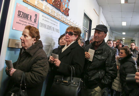 People wait to cast their votes for the referendum on constitutional reform, in Pontassieve, near Florence, northern Italy December 4, 2016. REUTERS/Paolo Lo Debole