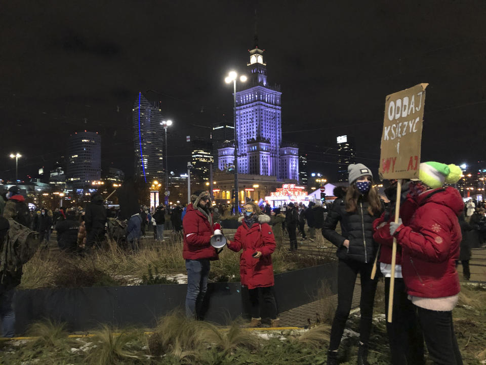 People gather in Warsaw, Poland Wednesday Jan. 27, 2021 to protest after the country's top court on Wednesday confirmed its highly divisive ruling that will further tighten the predominantly Catholic nation's strict anti-abortion law. The Constitutional Tribunal published the justification of its decision, which means it can now be officially printed and take immediate effect. (AP Photo/Czarek Sokolowski)