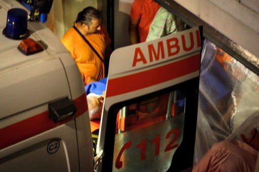 Former Romanian Prime Minister Adrian Nastase is loaded into an ambulance by emergency workers in Bucharest. Nastase attempted suicide Wednesday, hours after the Supreme Court threw out his appeal against a two-year jail sentence over corruption