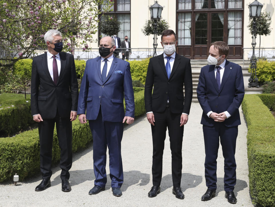 Slovak Foreign Minister Ivan Korcok, left,Polish Foreign Minister Zbigniew Rau, Hungarian Foreign Minister Peter Szijjarto and Czech Republic Foreign Minister Tomas Petricek,right, pose after meeting the foreign ministers of the Visegrad Group ,V4, in Lodz, Poland, Friday, May 14, 2021.(AP Photo/Czarek Sokolowski)