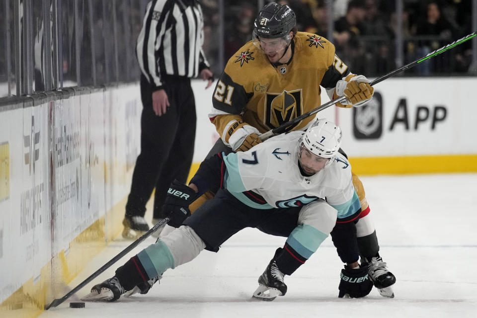 Seattle Kraken right wing Jordan Eberle (7) and Vegas Golden Knights center Brett Howden (21) vie for the puck during the first period of an NHL hockey game Tuesday, April 11, 2023, in Las Vegas. (AP Photo/John Locher)