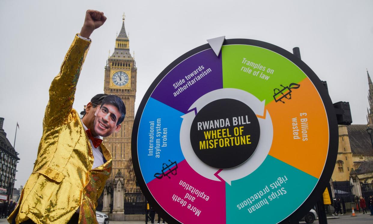 <span>A Rishi Sunak look-a-like spins a Rwanda bill 'Wheel of Misfortune' outside parliament earlier this month. Flights to Rwanda may well not now take off this spring as the prime minister hoped.</span><span>Photograph: Vuk Valcic/Zuma Press Wire/Rex/Shutterstock</span>