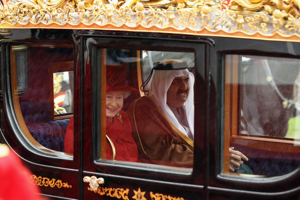 WINDSOR, ENGLAND - OCTOBER 26:  The Emir of Qatar, Sheikh Hamad bin Khalifa al Thani and Queen Elizabeth II make their way to Windsor Castle, on October 26, 2010 in Windsor, England. The Sheikh is on a two day State visit to the UK, the first since his last in 1985, which is seen as important in strengthening already strongly established business links with one of the Gulf States most financially powerful nations.  (Photo by Dan Kitwood - WPA Pool/Getty Images)