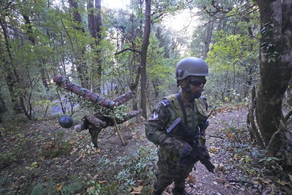 An Indian army soldier displays trap lane or booby traps working in a jungle during the Indo-US joint exercise or "Yudh Abhyas, in Auli, in the Indian state of Uttarakhand, Tuesday, Nov. 29, 2022. Militaries from India and the U.S. are taking part in a high-altitude training exercise in a cold, mountainous terrain close to India's disputed border with China. The training exercise began two weeks ago. India's defence ministry statement said the joint exercise is conducted annually with the aim of exchanging best practices, tactics, techniques and procedures between the armies of the two nations, which is under Chapter of the UN Mandate. (AP Photo/Manish Swarup)