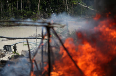 Machines are destroyed at an illegal cassiterite mine during an operation conducted by agents of the Brazilian Institute for the Environment and Renewable Natural Resources, or Ibama, in national parks near Novo Progresso, southeast of Para state, Brazil, November 4, 2018. REUTERS/Ricardo Moraes