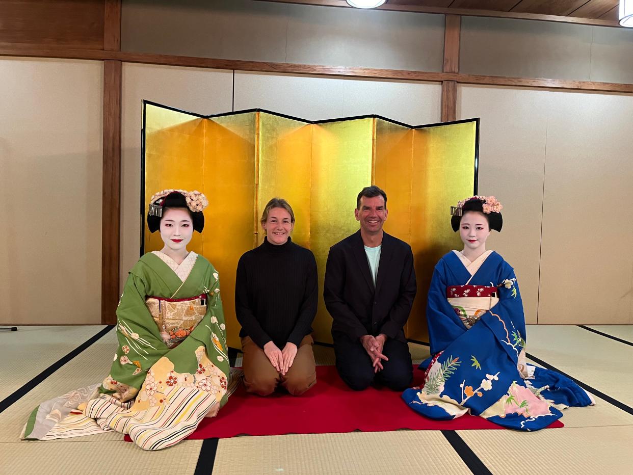 Margie and John Cullen sitting with two geisha at a traditional dinner after the race.