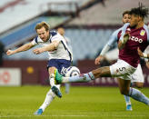 Tottenham's Harry Kane, left, takes a shot at goal as Aston Villa's Tyrone Mings attempts to block 131during the English Premier League soccer match between Aston Villa and Tottenham Hotspur at Villa Park in Birmingham, England, Sunday, March 21, 2021. (AP Photo/Tim Keeton,Pool)