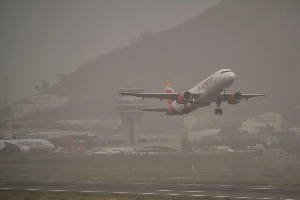 A passenger plane takes off from the Santa Cruz de Tenerife airport, Spain, Monday, Feb. 24, 2020.