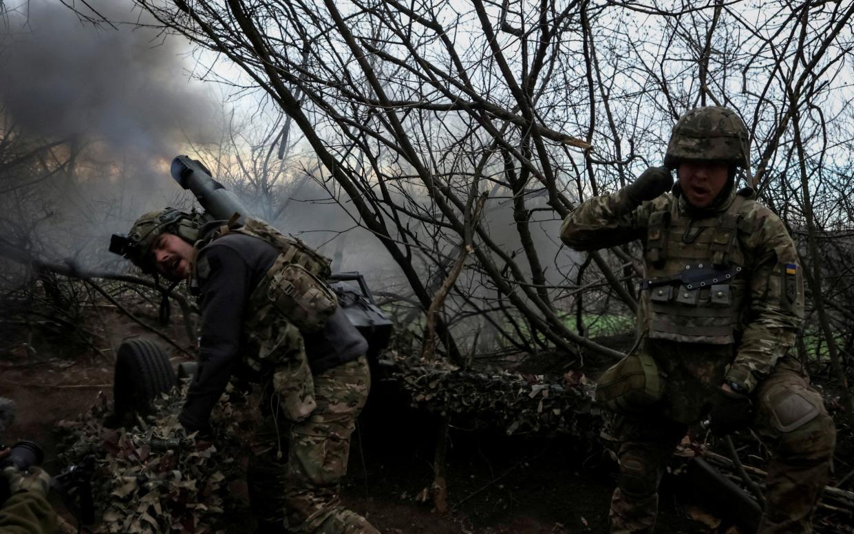 Servicemen of the 12th Special Forces Brigade Azov of the National Guard of Ukraine fire a howitzer towards Russian troops