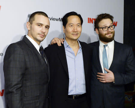 Cast members James Franco (L), Charles Rahi Chun (C) and Seth Rogen pose during premiere of the film "The Interview" in Los Angeles, California December 11, 2014. REUTERS/Kevork Djansezian