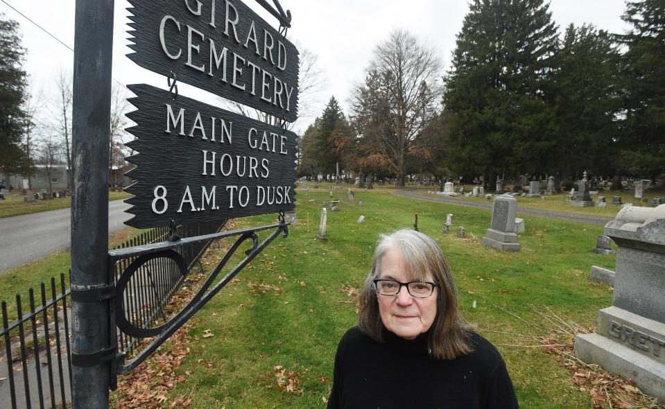 Stephanie Wincik is shown near the Girard Cemetery gatehouse.