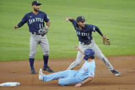 Seattle Mariners shortstop J.P. Crawford (3) throws to first after forcing out Texas Rangers' Charlie Culberson, bottom, at second base in the first inning of a baseball game Sunday, Aug. 1, 2021, in Arlington, Texas. Mariners second baseman Abraham Toro (13) looks on. (AP Photo/Louis DeLuca)