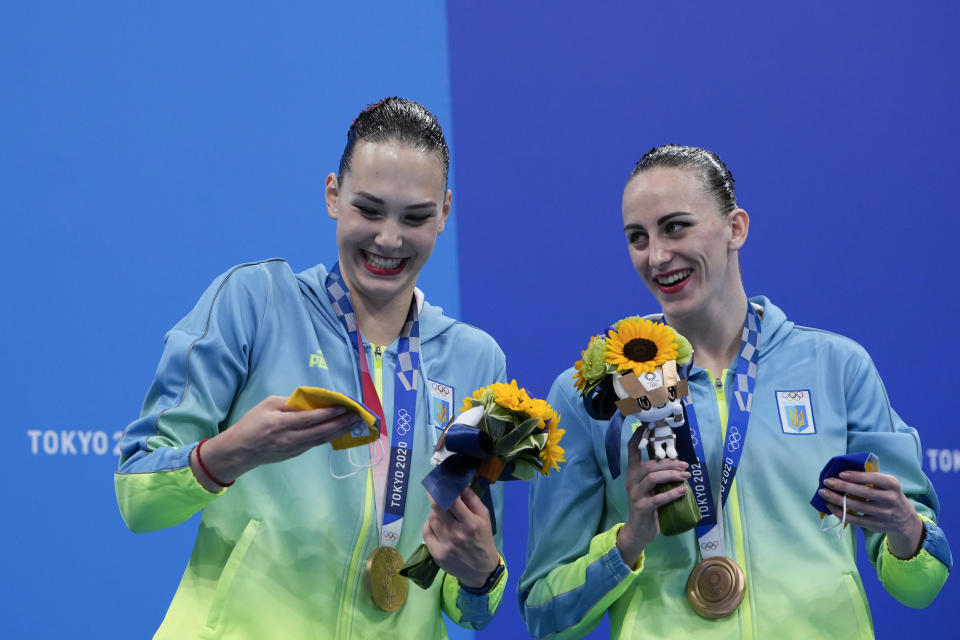 Third placed Marta Fiedina and Anastasiya Savchuk of Ukraine celebrate during the medal ceremony of the duet free routine final at the the 2020 Summer Olympics, Wednesday, Aug. 4, 2021, in Tokyo, Japan. (AP Photo/Alessandra Tarantino)