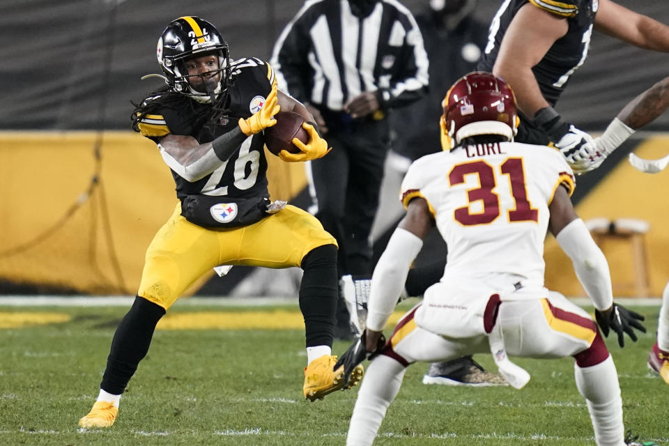 Pittsburgh Steelers running back Anthony McFarland (26) carries the ball with Washington Football Team strong safety Kamren Curl (31) defending during the second half of an NFL football game, Monday, Dec. 7, 2020, in Pittsburgh. (AP Photo/Keith Srakocic)