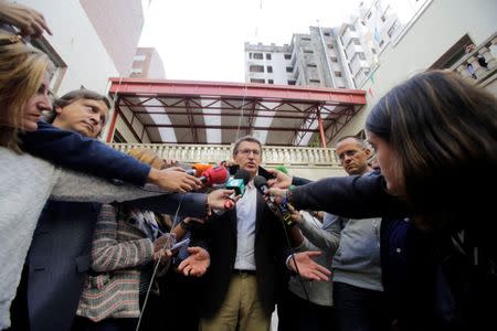 Galician President and member of the People's Party (PP) Alberto Nunez Feijoo talks to reporters outside a polling station after voting in Galician regional elections in Vigo, northern Spain, September 25, 2016. REUTERS/Miguel Vidal