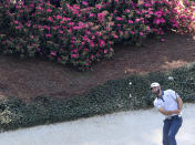 The azaleas are beginning to pop as Dustin Johnson hits his bunker shot to the 12th green during his practice round for the Masters at Augusta National Golf Club on Tuesday, April 6, 2021, in Augusta, Ga. (Curtis Compton/Atlanta Journal-Constitution via AP)