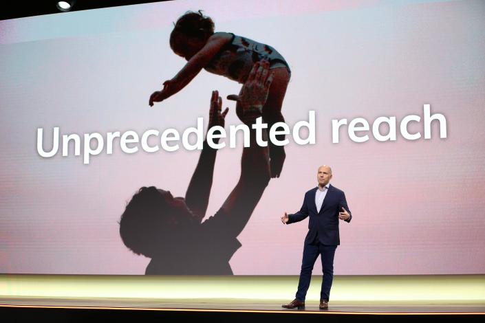 Expedia group ceo peter kern stands in front of a big screen saying he has never been able to reach a man who threw a child in the air