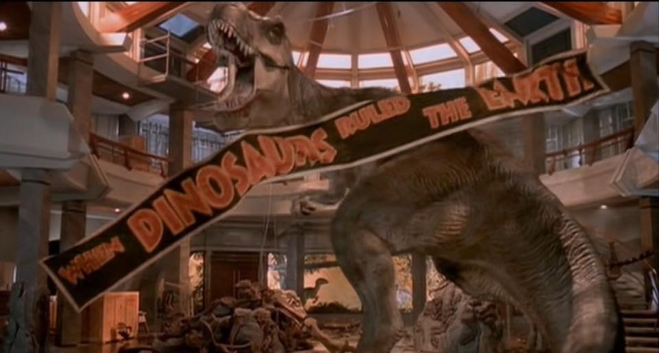 A T-Rex roaring with a banner falling in front of her in "Jurassic Park"