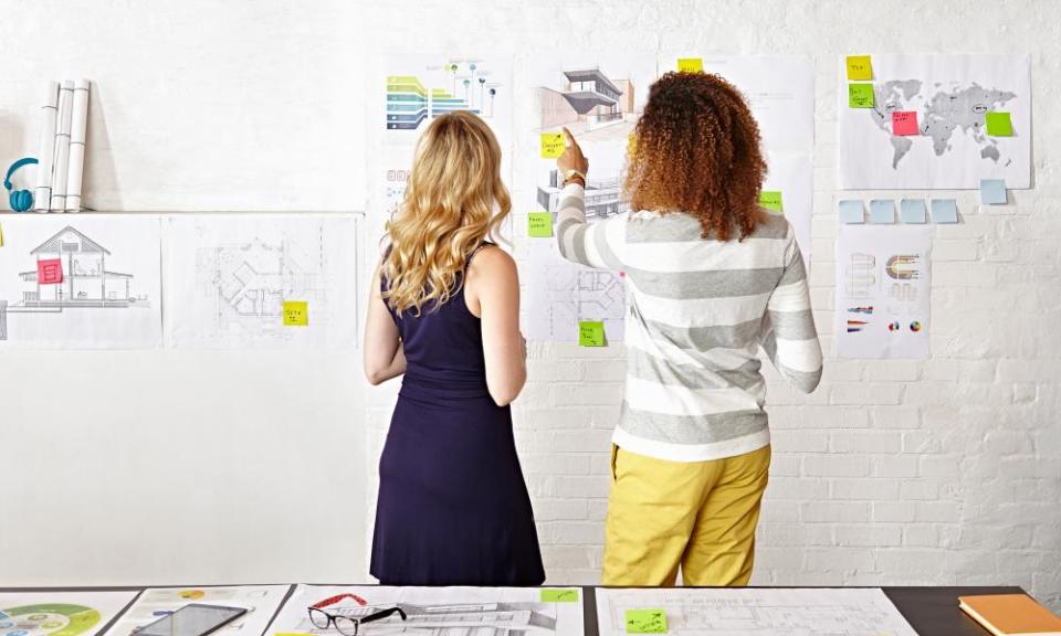 Work colleagues brainstorming in creative office.GettyImages-511069895