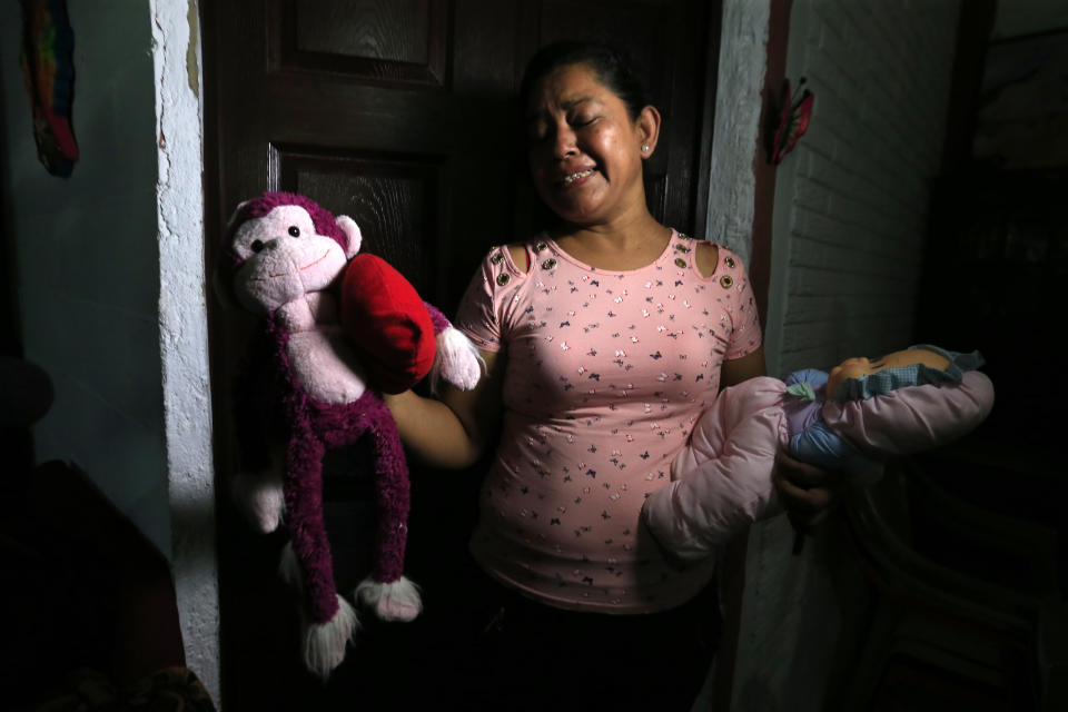 Rosa Ramirez sobs as she shows journalists toys that belonged to her nearly 2-year-old granddaughter Valeria in her home in San Martin, El Salvador, Tuesday, June 25, 2019. The drowned bodies of Ramirez's son, 25-year-old Oscar Alberto Martinez Ramirez, and his daughter were located Monday morning on the banks of the Rio Grande, a day after the pair were swept away by the current when the young family tried to cross the river to Brownsville, Texas. Her daughter-in-law Tania Vanessa Avalos, 21, survived. (AP Photo/Antonio Valladares)