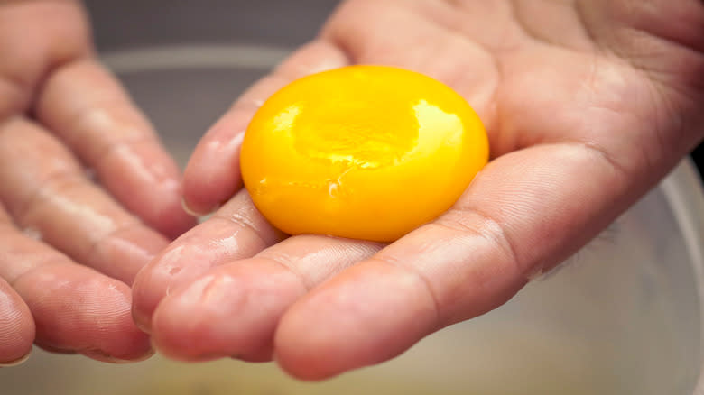egg yolk on bare hand
