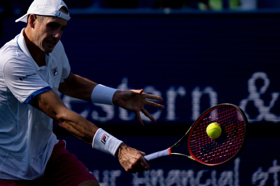 John Isner returns to Sebastian Korda during the second set of their match in the Western & Southern Open at the Lindner Family Tennis Center in Mason, Ohio, on Thursday, Aug. 18, 2022. 