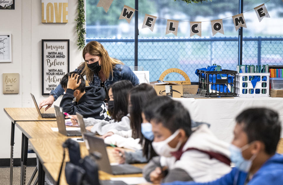 Lori Manz, a curriculum specialist at the Ocean View School District in Huntington Beach, Calif., substitute teaches in a seventh-grade math class at Vista View Middle School on Jan. 20. (Photo by Paul Bersebach/MediaNews Group/Orange County Register via Getty Images)