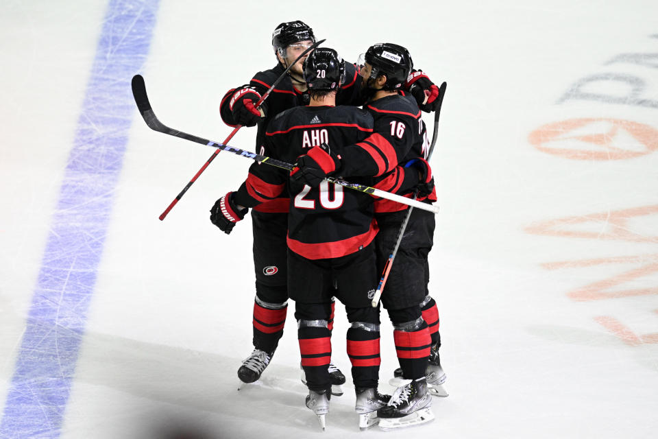 RALEIGH, NC - MAY 20: Carolina Hurricanes Right Wing Jesper Fast (71), Carolina Hurricanes Center Vincent Trocheck (16), and Carolina Hurricanes Center Sebastian Aho (20) celebrate after scoring an empty net goal during game 2 of the second round of the Stanley Cup Playoffs between the New York Rangers and the Carolina Hurricanes on May 20, 2022 at PNC Arena in Raleigh, North Carolina. (Photo by Katherine Gawlik/Icon Sportswire via Getty Images)