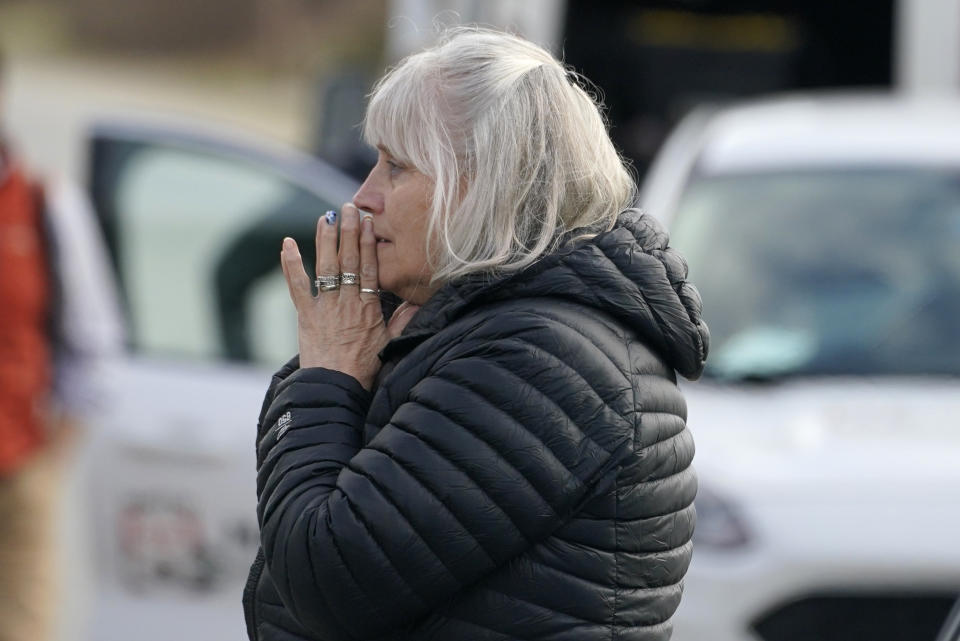 FILE - A woman reacts at the scene of a multiple shooting, Tuesday, April 18, 2023, in Bowdoin, Maine. Four people were found fatally shot in a Maine home shortly before gunfire injured three others on a busy highway 25 miles away in a pair of crimes that were linked, state police said. The U.S. is setting a record pace for mass killings in 2023, replaying the horror in a deadly loop roughly once a week so far this year. The bloodshed overall represents just a fraction of the deadly violence that occurs in the U.S. annually. (AP Photo/Robert F. Bukaty, File)