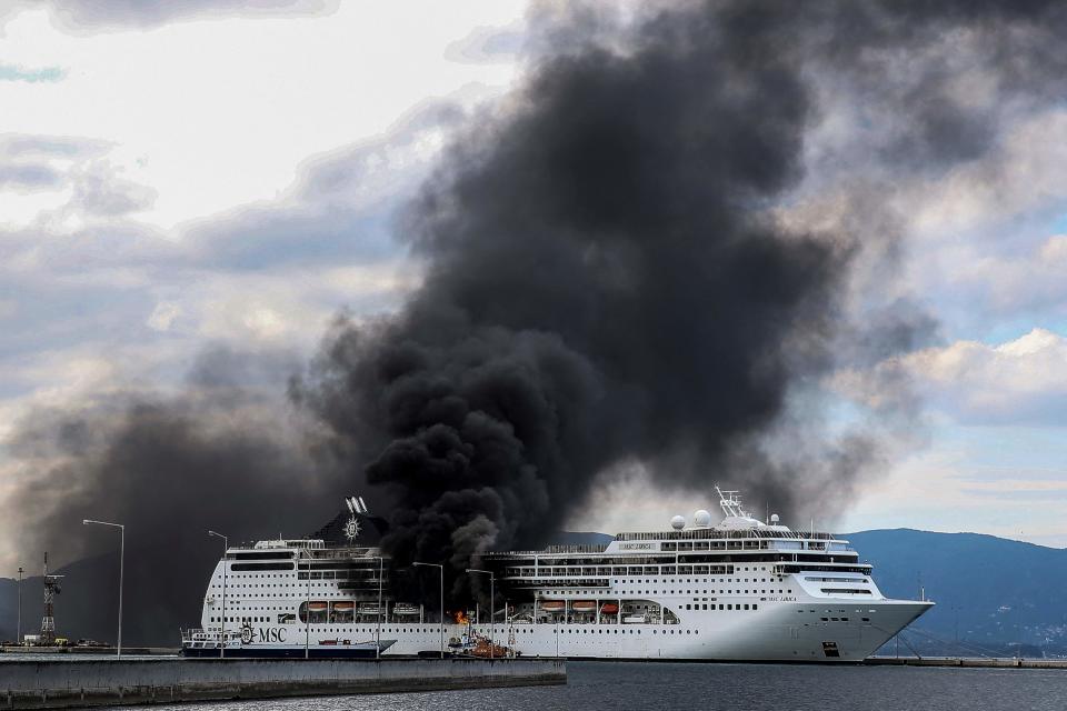 Cruiser MSC Lirica is pictured on fire, while docked in the port of the Greek island of Corfu on March 12, 2021. The fire is under control and no injuries were reported.