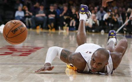 Los Angeles Lakers Kobe Bryant dives for a loose ball during their NBA game against the Chicago Bulls in Los Angeles, March 10, 2013. REUTERS/Lucy Nicholson