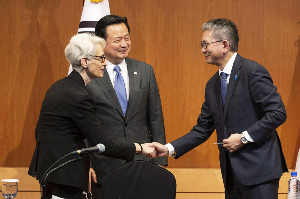 U.S. Deputy Secretary of State Wendy Sherman, left, shakes hands with Japanese Vice Minister for Foreign Affairs Takeo Mori as South Korea's First Vice Foreign Minister Cho Hyun-dong smiles after a joint news conference at the Foreign Ministry in Seoul, South Korea, Wednesday, June 8, 2022. (Jeon Heon-Kyun/Pool Photo via AP)